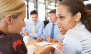 Businesswomen Talking To Each Other During Meeting